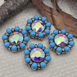 These turquoise and AB crystal 2 hole slider beads feature a faceted aurora borealis rhinestone center surrounded by round turquoise beads. Set in antique silver metal with decorative spacer accents, these metal slide spacer beads are perfect for two strand bracelet and necklace jewelry making. They pair beautifully with seed beads, duo beads, gemstones, and leather cords for boho, western, and handmade DIY jewelry designs.
