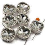 Faceted square crystal rhinestone double hole beads in full silver bezel setting. These unique findings work beautifully as spacer beads and rhinestone connectors in bridal jewelry, bohemian designs, and vintage-inspired pieces. Compatible with CzechMates, carrier beads, and SuperDuo systems. Perfect for wire wrapping, stringing, and bead weaving projects.