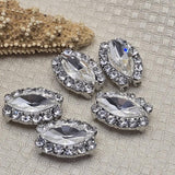 These stunning oval 2 hole slider beads feature a large faceted clear rhinestone in an encrusted platinum silver border setting. Hard to find focal beads that instantly elevate any jewelry design. Perfect for bead weaving, pendant necklaces, and statement bracelets. Pair with Czech glass, SuperDuo, turquoise, hematite, and seed beads as supporting components around them.