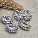 These oval clear rhinestone 2 hole spacer beads feature a brilliant faceted center with full encrusted rhinestone border in platinum silver. Rare focal beads for statement bracelets, pendant designs, and bead embroidery. Use as centerpiece or bead weaving anchor alongside seed beads, freshwater pearls, turquoise, and hematite. Unique hard to find findings for jewelry makers and beaders.