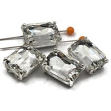 Large clear rhinestone emerald cut 2 hole slider beads in open back platinum silver prong setting. Rare architectural focal beads for bridal accessories, formal jewelry, and bohemian designs. Perfect anchor point for peyote stitch, loom work, and bead weaving projects. Pair with freshwater pearls, hematite, semi-precious stones, and seed beads as supporting components.