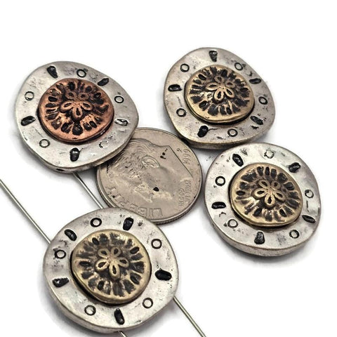 Create beautiful coastal jewelry with these detailed sand dollar two hole slider beads. Featuring a raised sea life medallion center with antique silver, brass, and copper tones, these beads add texture and dimension to handmade designs. The two hole design makes them perfect for double strand bracelets and necklaces using leather cord or wire. Ideal for beach jewelry, nautical accessories, ocean inspired jewelry, and sea life themed craft projects.
