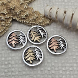 These detailed round tree slider beads feature a light pewter silver frame with raised pine trees in mixed metal finishes. Designed for double strand jewelry, they are perfect for bracelets and necklaces using leather cord, beading wire, or thread. Pair them with seed beads, duo beads, Czech beads, gemstone beads, and crystal beads to create woodland jewelry, rustic nature accessories, and forest inspired handmade designs.