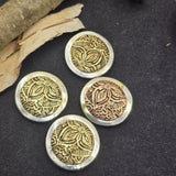 These detailed round floral slider beads feature a decorative western inspired flower pattern set in a silver tone frame with antique brass and copper accents. Perfect for use as focal beads, they add texture and depth to handmade jewelry designs. The two hole construction makes them ideal for double strand bracelets and necklaces. Great for rustic jewelry, boho western accessories, and southwestern style handmade jewelry.