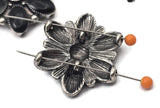 Create eye catching jewelry with these black enamel floral focal beads. The detailed petal design and antique silver tone setting give these beads a bold western and southwestern style. Perfect for use in double strand bracelets and necklaces, they pair beautifully with leather cord, gemstone beads, and metal spacers. Ideal for western jewelry makers, cowgirl designs, and statement jewelry pieces.