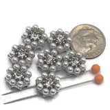 Beautiful 2 hole metal slider beads in a platinum silver finish, designed with radiant clear rhinestones and delicate faux pearls in a floral cluster. These beads are perfect for bracelet and necklace jewelry making, especially double strand designs. Pair effortlessly with seed beads, duo beads, or glass beads to create elegant, high-end looks ideal for weddings, formal jewelry, or feminine handcrafted accessories.