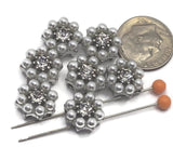 Add a touch of luxury to your jewelry making with these pearl and rhinestone slider beads in a silver tone finish. The two hole design makes them perfect for multi-strand bracelets and necklaces. Featuring a sparkling crystal center surrounded by soft faux pearls, they pair beautifully with seed beads, duo beads, or metal beads for creating bridal, vintage, or glam-inspired jewelry designs.