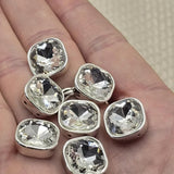 These sparkling square rhinestone 2 hole slider beads in platinum silver bezel are must-have unique findings for any beader or crafter. Brilliant faceted cut glass double hole spacer beads perfect for bridal accessories, statement necklaces, and layered bracelets. Compatible with CzechMates, tile beads, SuperDuo, and other two hole bead weaving designs.