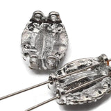 These glamorous oval 2 hole slider beads feature a faceted clear rhinestone center with decorative encrusted border in platinum silver. Hard to find focal beads perfect for statement jewelry, bead weaving, and pendant necklace designs. Pair with turquoise, hematite, crystal beads, and seed beads as supporting components. Unique findings for experienced beaders and jewelry designers.