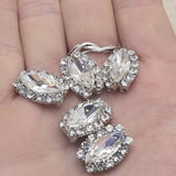 Clear rhinestone oval 2 hole slider beads in platinum silver encrusted border setting, 18mm x 13mm, 5mm between holes. Rare focal beads perfect for statement necklaces, bracelets, and bead weaving projects. Use as a single centerpiece or anchor point in peyote stitch and loom work. Pair with seed beads, turquoise, hematite, and Czech glass. Unique hard to find jewelry making findings for beaders and crafters.