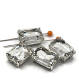 These rectangular clear rhinestone 2 hole spacer beads feature a geometric emerald cut stone in platinum silver open prong setting. Hard to find focal beads perfect for statement necklaces, stretch bracelets, and bead embroidery. Pair with Czech glass, SuperDuo, turquoise, and seed beads around them. Unique rhinestone findings for experienced beaders and jewelry designers.