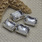 Clear emerald cut rhinestone 2 hole slider beads in open back platinum silver prong setting. These rare rectangular focal beads are stunning findings for bridal jewelry, vintage-inspired necklaces, and modern minimalist designs. Anchor in peyote stitch or loom work, or use as single centerpiece pendant. Pair with hematite, seed beads, freshwater pearls, and semi-precious chips.