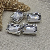 Emerald cut clear rhinestone double hole focal beads in open back platinum silver prong setting. These rare 2 hole slider beads are stunning architectural findings for bridal jewelry, vintage-inspired designs, and modern statement pieces. Use as single centerpiece pendant or bead weaving anchor. Pair with hematite, semi-precious chips, crystal beads, and seed beads as supporting components.