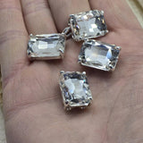 These large rectangle clear rhinestone 2 hole spacer beads feature an architectural emerald cut stone in platinum silver open prong setting. Rare hard to find focal beads for statement jewelry, bead weaving, and bridal accessories. Use as centerpiece or loom work anchor alongside seed beads, turquoise, Czech glass, SuperDuo, and crystal bead supporting components.