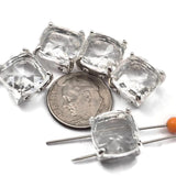 Sparkling clear resin rhinestone square double hole focal beads in open back platinum silver prong setting. These rare lightweight 2 hole slider beads are stunning findings for bridal accessories, bohemian designs, and bead weaving projects. Anchor in peyote stitch or loom work, or pair with seed beads, crystal beads, semi-precious chips, and freshwater pearls.