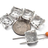 Lightweight clear rhinestone square 2 hole slider beads in open back platinum silver prong setting. These rare resin rhinestone focal beads are perfect for earrings, multi-strand necklaces, and bead weaving anchor points in peyote stitch and loom work. Pair with seed beads, amethyst chips, crystal beads, and freshwater pearls as supporting components.