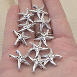 Antique silver starfish 2 hole slider beads, 21mm x 21mm, 8.5mm between holes, qty 10. Rare hard to find coastal focal beads with detailed textured finish perfect for beach inspired jewelry, boho necklaces, and nautical bracelet designs. Pair with turquoise, freshwater pearls, coral, seed beads, and hematite as supporting components. Perfect anchor point for peyote stitch and loom work. Unique metal findings for beaders and jewelry designers.