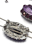 Sparkling violet Rhinestone Slider Beads arranged beside a dime on a white background. Each marquise-shaped bead showcases a faceted purple center stone surrounded by light amethyst rhinestones set in silver-tone metal. The dual-hole construction helps maintain strand alignment in jewelry designs. Ideal for handmade bracelets, necklaces, pendants, bead weaving, Peyote Stitch projects, and elegant multi-strand jewelry creations that require eye-catching focal beads.