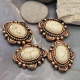 Beautiful western-inspired 2 Hole Slider Beads featuring ivory faux marble stones framed by richly detailed antique copper settings. The warm copper finish complements the neutral stone colors and creates a timeless rustic look. Shown with beading pins for reference, these focal beads are suitable for bracelet making, necklace designs, leather jewelry, artisan creations, and Southwestern-style handmade jewelry projects.