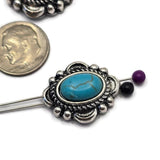 Large western-style focal beads with oval faux turquoise stones framed by textured antique silver accents. The classic turquoise and silver color combination is popular in Southwestern jewelry designs. Displayed beside a dime for size comparison, these 2 Hole Slider Beads work beautifully in handmade bracelets, necklaces, artisan beadwork, leather jewelry, and rustic fashion accessories.
