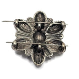 Antique silver flower slider beads featuring smooth cream enamel petals and decorative raised accents throughout the design. The flower shape creates a classic focal component for jewelry projects. Displayed beside a dime for size reference, these 2 Hole Slider Beads are suitable for handmade bracelets, necklaces, artisan jewelry, bridal designs, and floral accessories.