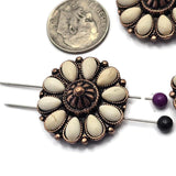 Large floral 2 Hole Slider Beads featuring cream-colored faux stone details arranged around a decorative antique copper center. The western-inspired styling creates a bold focal point for jewelry projects. Displayed beside a dime and threaded with beading pins, these beads are perfect for bracelet making, necklace designs, leather accessories, custom jewelry, and artisan-crafted statement pieces.