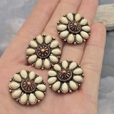 Decorative flower focal beads with cream faux stone accents and antique copper settings. The warm copper finish highlights the intricate floral design while the neutral ivory tones complement many jewelry styles. Shown with a dime for scale, these dual-hole slider beads work beautifully in leather jewelry, statement necklaces, bracelets, artisan beadwork, and handcrafted western creations.