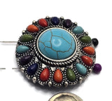 Large decorative slider bead photographed from the back and front, showing both the colorful faux stone design and dual-hole construction. The faux turquoise center stone is surrounded by bright accent stones set in antique silver metal. This oversized focal bead is suitable for western bracelets, statement necklaces, custom jewelry, artisan beadwork, and handcrafted fashion accessories.