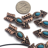 Western-style 2 Hole Slider Beads shaped like arrows with oval faux turquoise center stones. The antique copper finish highlights the detailed metalwork and creates contrast against the bright turquoise color. Ideal for leather jewelry, handcrafted bracelets, statement necklaces, beadwork projects, custom jewelry, and Southwestern-inspired fashion accessories.