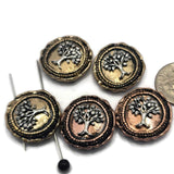 Beautiful round focal beads featuring symbolic Eternal Life Tree motifs in antique copper and light antique gold metal finishes. The raised tree design creates texture and dimension while the dual-hole construction supports multi-strand jewelry projects. Displayed with a dime for scale, these beads are suitable for bracelets, necklaces, pendants, and artisan handcrafted jewelry.