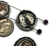 Mixed-metal Tree of Life slider beads displayed on a hand to show scale and detail. The raised tree motifs stand out against textured antique silver backgrounds, creating a symbolic and decorative focal bead. Perfect for handmade bracelets, necklaces, pendants, spiritual jewelry, artisan accessories, and inspirational jewelry collections.
