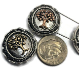 Decorative Tree of Life 2 Hole Slider Beads with antique silver settings and raised mixed-metal tree designs. The symbolic imagery represents growth, wisdom, family, and renewal. Displayed on a hand for reference, these focal beads are ideal for bracelets, necklaces, artisan jewelry collections, inspirational accessories, and handcrafted gifts.