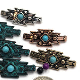 Decorative geometric focal beads with faux turquoise center stones and detailed floral accents. The assortment includes antique silver, antique copper, antique brass, and verdigris finishes that complement western and Southwestern jewelry styles. Shown with a dime for size comparison, these dual-hole slider beads are perfect for bracelets, necklaces, bead weaving, artisan accessories, leather jewelry, and handcrafted fashion designs.
