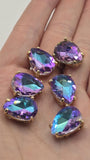 Faceted Amethyst Aqua AB rhinestone slider bead in a gold setting. This teardrop-shaped focal bead features dual stringing holes and brilliant purple, turquoise, and blue reflections. Perfect for bead weaving, bracelet making, necklace designs, and artisan jewelry projects.