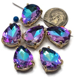Teardrop-shaped Purple Aqua AB rhinestone bead with gold prong setting and dual stringing holes. The faceted surface reflects vibrant shades of amethyst purple, turquoise, aqua blue, and teal. These eye-catching slider beads are ideal for statement jewelry, fantasy-inspired designs, bracelets, necklaces, and artisan beadwork creations.