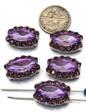 Purple marquise focal beads with faceted violet stones and sparkling amethyst rhinestone borders arranged for product photography. The silver-tone finish adds brightness and contrast to the design. A dime is visible for size reference, while a beading pin illustrates the dual-hole feature. These 2 Hole Slider Beads are excellent for handmade jewelry, custom bracelets, necklaces, pendants, and multi-strand beading projects requiring elegant focal components.