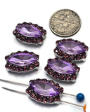 Decorative 2 Hole Slider Beads featuring faceted lavender violet center stones surrounded by shimmering light amethyst rhinestones. The marquise shape and silver-tone settings create a timeless jewelry component suitable for many styles. Photographed with a dime and beading pin for scale, these dual-hole focal beads can be used in bracelets, necklaces, earrings, pendants, bead weaving, and other handmade jewelry making applications.