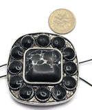 Large western-style 2 Hole Slider Bead featuring a square faux marble center stone with white veining surrounded by oval black stones in an antique silver setting. Displayed beside a dime for size reference, this oversized focal bead includes dual holes for multi-strand jewelry construction. Ideal for handmade bracelets, western necklaces, statement jewelry, leather jewelry designs, custom accessories, and Southwestern-inspired jewelry making projects.