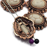 Western focal beads showcasing faux marble center stones with subtle natural-looking veining set in warm antique copper frames. The oval shape and decorative metalwork create a classic rustic appearance. Photographed with beading pins for construction reference, these slider beads are perfect for handmade bracelets, layered necklaces, leather jewelry, beadwork, and artisan jewelry making supplies.