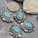 Southwestern-inspired focal beads showcasing oval faux turquoise stones with realistic matrix veining set in antique silver metalwork. The dual-hole design allows secure placement in multi-strand jewelry projects. Displayed with a dime for scale, these slider beads are suitable for bracelet making, necklace designs, leather jewelry, bead weaving, and artisan handmade jewelry collections.