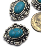 Decorative 2 Hole Slider Beads featuring bright faux turquoise stones in richly detailed antique silver settings. The western styling combines classic turquoise color with rustic silver accents for a timeless jewelry component. A dime demonstrates size while beading pins show the stringing holes. Perfect for custom bracelets, statement necklaces, artisan jewelry, and handcrafted western accessories.
