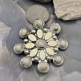 Large round focal bead with cream and white enamel marquise accents set in detailed antique silver metal. Decorative circular elements surround the outer edge, creating a floral western appearance. The dual-hole construction supports multi-strand jewelry designs. Perfect for handmade bracelets, necklaces, statement pendants, custom jewelry, and Southwestern-inspired artisan creations.