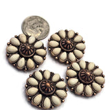 Antique copper 2 Hole Slider Beads featuring cream-colored faux stone petals arranged in a circular flower pattern. The raised center detail and decorative metalwork add texture and dimension to the design. Displayed with a dime and beading pins for reference, these focal beads are excellent for handmade bracelets, necklaces, artisan jewelry, beadwork, and Southwestern-style accessories.