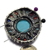 Oversized round focal bead with faux turquoise, colorful accent stones, and detailed antique silver metalwork. Displayed on a hand for size reference, the bead features a vibrant Southwestern-inspired color palette that creates a dramatic centerpiece. Perfect for handmade jewelry, bracelets, necklaces, artisan accessories, western designs, and custom statement jewelry projects.