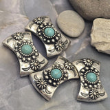 Decorative western slider beads with faux turquoise center stones framed by detailed silver beadwork and floral accents. The antique silver finish highlights the intricate design while creating rustic character. Perfect for bracelet making, layered necklaces, custom jewelry, leather projects, artisan beadwork, and handcrafted western fashion accessories.