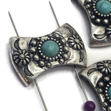 Western-style curved focal beads with turquoise-look center stones and ornate antique silver settings. Decorative floral and crescent-inspired accents surround the center stone and create a distinctive artisan appearance. Suitable for bracelets, necklaces, leather jewelry, bead weaving, custom accessories, and Southwestern-inspired handmade jewelry collections.