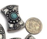 Curved western 2 Hole Slider Beads with faux turquoise center stones and detailed silver metalwork. The combination of turquoise and antique silver creates a timeless Southwestern color palette popular in handmade jewelry. Ideal for bracelets, necklaces, artisan beadwork, custom jewelry, western fashion accessories, and rustic handcrafted creations.
