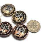 Mixed metal Tree of Life slider beads featuring symbolic tree imagery and textured decorative borders. The antique copper and light antique gold finishes create a rustic vintage appearance suitable for many jewelry styles. Displayed with a dime for scale, these beads are excellent for bracelets, necklaces, custom jewelry, and meaningful handmade gifts.