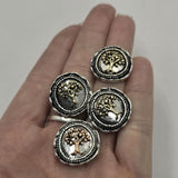 Round 2 Hole Slider Beads with detailed Tree of Life motifs in mixed antique copper and light antique gold finishes. Decorative beaded borders and textured silver backgrounds create a vintage-inspired appearance. Displayed on a hand for size comparison, these beads are suitable for bracelets, necklaces, pendants, and meaningful handmade jewelry designs.