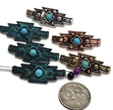 Geometric 2 Hole Slider Beads showcasing turquoise-look center stones surrounded by decorative mixed-metal settings. The assortment includes several finishes, allowing jewelry makers to coordinate with a variety of western and Southwestern themes. Displayed beside a dime for scale, these focal beads are suitable for Bracelet Making, Necklace Designs, leather jewelry, artisan accessories, and custom handcrafted jewelry creations.